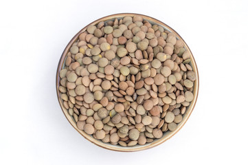 group of raw lentils in a bowl on white background