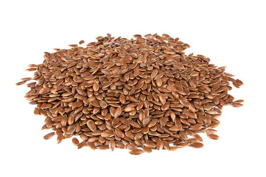Linseed on a white background. Also known as Linseed, Flaxseed and Common Flax. Pile of grains, isolated white background.