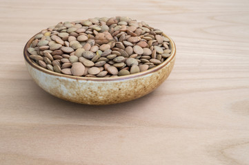 lentils inside a bowl on wooden table