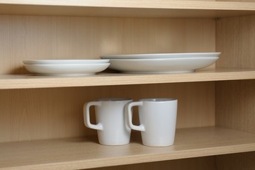 Fototapeta na wymiar Kitchen cupboard with white cups. Live at home with my husband and wife. live together. Scandinavian style