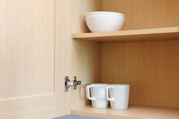 Kitchen cupboard with white cups. Live at home with my husband and wife. live together. Scandinavian style