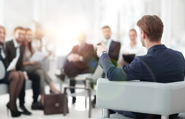 image is blurred.businessman conducting a meeting