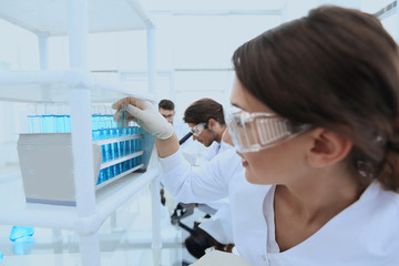 Obraz premium Young woman with test tubes in the laboratory