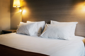 pillows on the large double bed. The concept of preparing a bed in a hotel room or at home. Modern interior