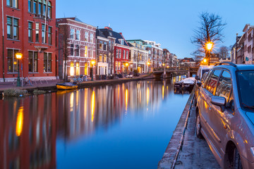 Fototapeta na wymiar Cityscape - evening view of the city canal with bridge and boats, the city of Leiden, Netherlands