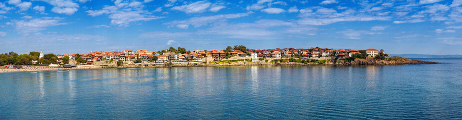 Fototapeta na wymiar Seaside landscape, panorama, banner - view of the embankment with fortress wall and beach in the city of Sozopol on the Black Sea coast in Bulgaria