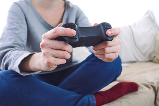 man holding a joystick controllers while playing a video games at home