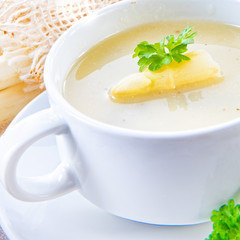 asparagus cream soup with capers and fresh baguette