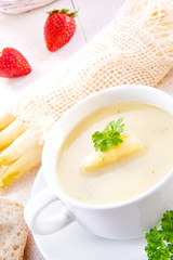 asparagus cream soup with capers and fresh baguette