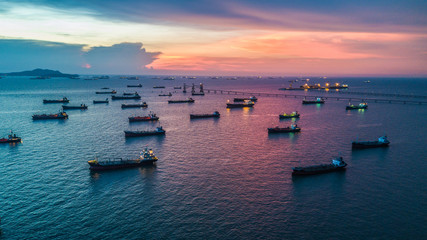 Aerial view tanker ship anchor parking in sea, Crude oil tanker ship and LPG tanker ship loading in bay at sunset, Bulk boat anchor.  - obrazy, fototapety, plakaty