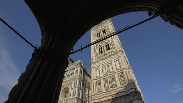 A cathedral facade seen from an arched portico