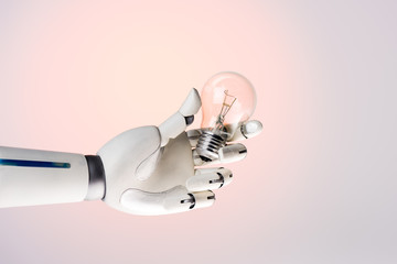 robot hand holding lamp isolated on beige