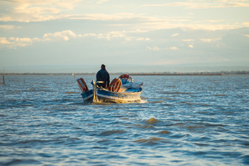 Fisherman on the boat at sunset in L'Albufera, Spain