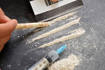 A drug addict splitting drug doses
