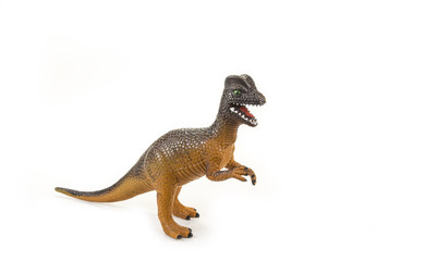 Dinosaur toy with open mouth on the white