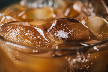close up view of ice cubes in cold brewed coffee in glass