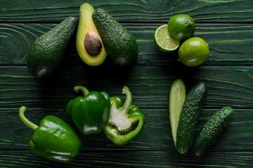 top view of cut green vegetables and fruit on wooden table, healthy eating concept