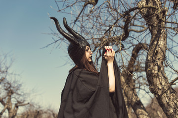 Brunette in a spring apple orchard