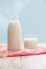 Dairy products. Bottle with milk and glass of milk on wooden table