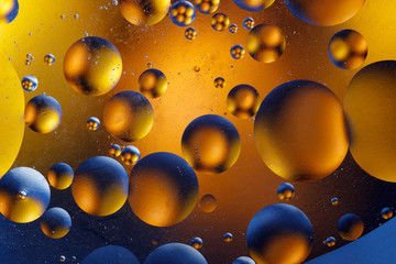 Oil bubbles in an aqueous medium on the border with a glass surface. Abstract Screen Saver.