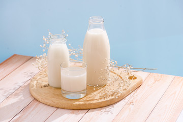 Dairy products. Bottle with milk and glass of milk on wooden table