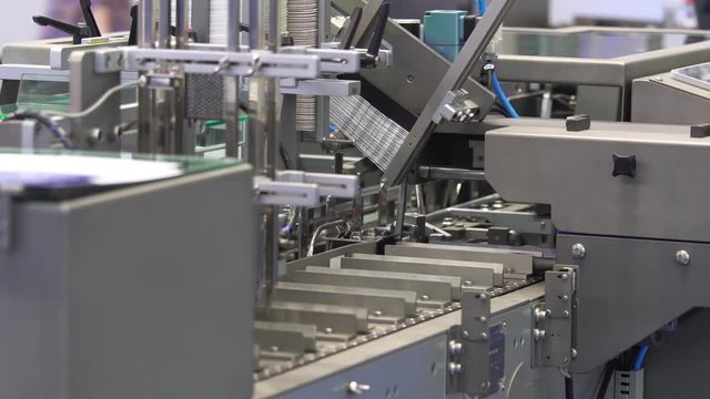 Automatic cartoning packaging machine in medical industry, close up view process