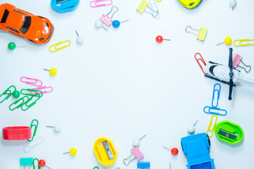 Top view of paper clips with toys on white background