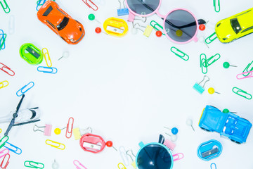 Top view of paper clips with toys on white background
