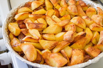 Homemade baked potatoes with spices in a form 