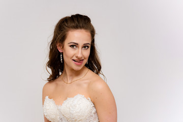 beautiful bride in white wedding dress in different poses on white backgrounds shows different emotions