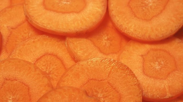 Sliced carrot close-up. Food texture. Smoothly rotates. Vegetarian diet
