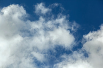 Background of transparent white clouds in a light blue sky,