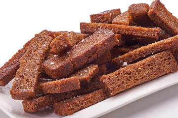 Fried crackers of brown bread isolated on white background.