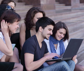 friends of the students looking at the laptop screen