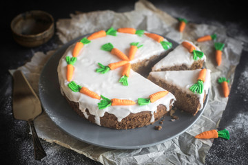 Whole homemade and glazed carrot cake served on the plate,selective focus