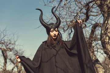 Brunette in a spring apple orchard