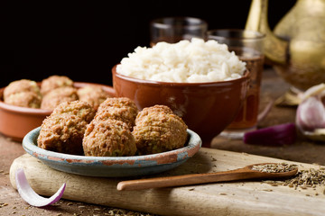 falafel and long grain rice on a wooden table