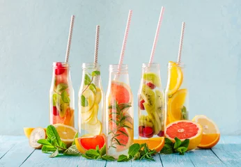 Fotobehang Variety of fruit infused detox water in small bottles. Set of refreshing summer drinks. Healthy diet eating concept. © yakky