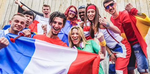 Group of happy sport supporters having fun during football world game