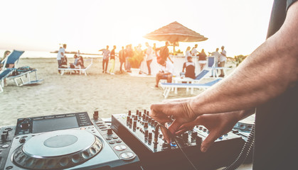 Dj mixing at sunset beach party in summer vacation outdoor
