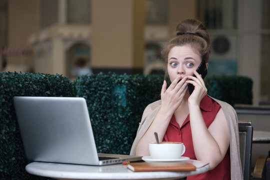 Young caucasian woman with smartphone getting bad news, looks shocked