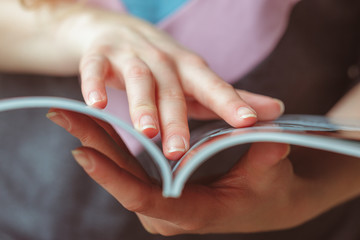 woman reading magazine at home