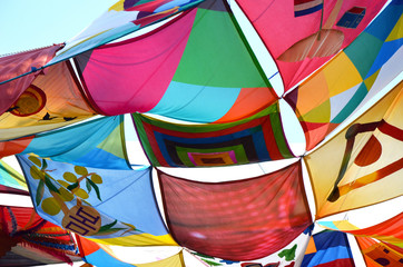 Colorful vibrant summer festival fabric tent sails blowing in the breeze