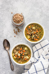 Golden lentil barley spinach soup. Top view, space for text.