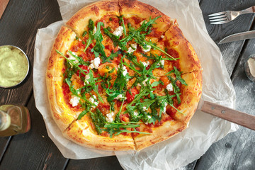 delicious italian pizza served on wooden table top view