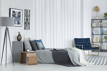 Grey bedroom interior with armchair