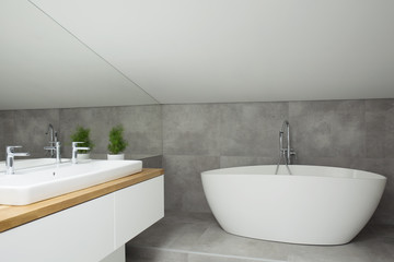 Fototapeta na wymiar Grey bathroom interior with bathtub