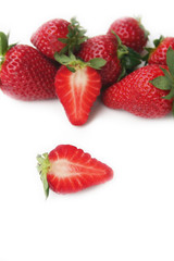 Fototapeta na wymiar Whole and half strawberries isolated on white background
