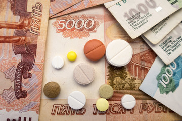 Different types of tablets located on Russian rubles close-ups