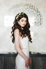 Obraz premium Portrait of the bride, who is waiting for the groom. Brunette Woman with Long and shiny Curly Hair. Beautiful Model Lady with Curly Hairstyle. Hair Care and Beauty products. Care and Beauty of Hair.